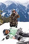 Injured Skier with Friend on Hillside