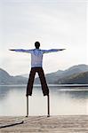 Man Balancing on Dock Ladder, Fuschlsee, Fuschl am See, Salzkammergut, Salzburger Land, Austria