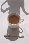 Shadow of Teapot Over Cup of Tea