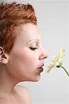 Portrait of Woman Smelling a Flower