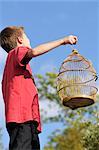 Boy Holding Empty Birdcage