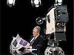 News presenter reading newspaper