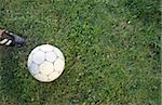 Foot of a Boy next to Leather-Football - Leisure Time Sports - Meadow