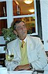 Old Man sitting on a Lawn Seat in front of a Window - Festivity - Party - Wedding