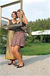 Someone taking Pictures of two young Women trough a Frame - Family Party - Garden