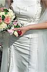 Woman in a Wedding Dress holding a Bunch of Flowers in her Hand - Symbolism - Wedding