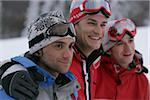 Three Men with Ski Clothing standing together and laughing