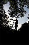 Silhouette of a Jogger relaxing and drinking water