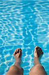 Man with feet in swimming pool