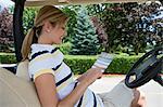 Woman with Score Card in Golf Cart, Burlington, Ontario, Canada