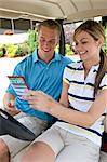 Couple with Score Card in Golf Cart, Burlington, Ontario, Canada
