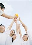 Elementary school students catching a ball