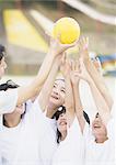Elementary students catching a ball