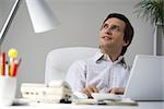 Man sitting at desk, looking up