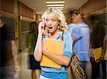 High School girl at school on mobile phone.