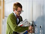 Nerd trying to open his locker.