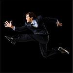 Young man running in a suit.