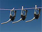 Gas pump handles on a clothes line.