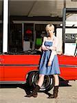 woman with cowboy boots at a gas station.