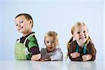 three children in aprons