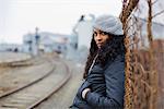 Woman Leaning Against a Fence in Urban Industrial Area, Portland, Oregon, USA