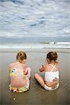 Girls Sitting on Beach, Cape Hatteras, North Carolina, USA
