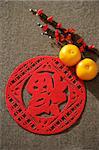 Still life of pair of mandarin oranges with Chinese character for "fortune"