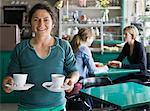 Portrait of a female barista at a cafe