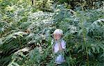 Boy hiding in ferns