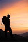 Hiker looking at the sunrise.