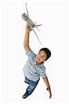 Boy Playing with Toy Airplane