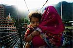 Mother Carrying Son Across Bridge, Rishikesh, India