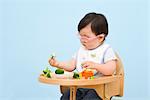 Baby Eating in Highchair