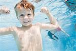 Boy Flexing Muscles Underwater