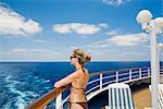 Woman in Bikini Looking at Ocean from Stern of Cruise Ship