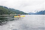 Woman kayaking in fjord