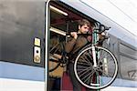 Man with bike on train