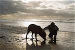 Garçon au bord de mer avec chien