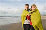Children in blanket by the sea