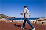 Man Nordic Walking by the Sea