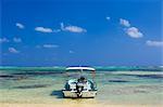 Boat Anchored in Shallow Water Surrounded by Coral Reefs, Ishigaki Island, Yaeyama Islands, Okinawa, Japan