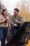 Couple Drinking Beer by an Outdoor Fireplace, Bend, Oregon, USA