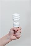 Child Holding Energy Efficient Lightbulb