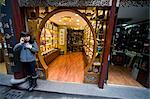 Woman Standing in Front of Store, Talking on Cell Phone, Shanghai, China