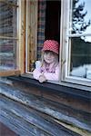 Girl Looking out Cabin Window