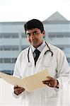 doctor holding patient file
