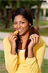 woman eating orange outside