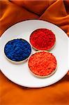 red, blue and orange Indian powder paints