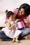 woman with baby, opening her present