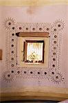 Raised mud reliefs inlaid with mirror on the walls of modern home in traditional tribal Rabari round mud hut, Bunga style, near Ahmedabad, Gujarat state, India, Asia